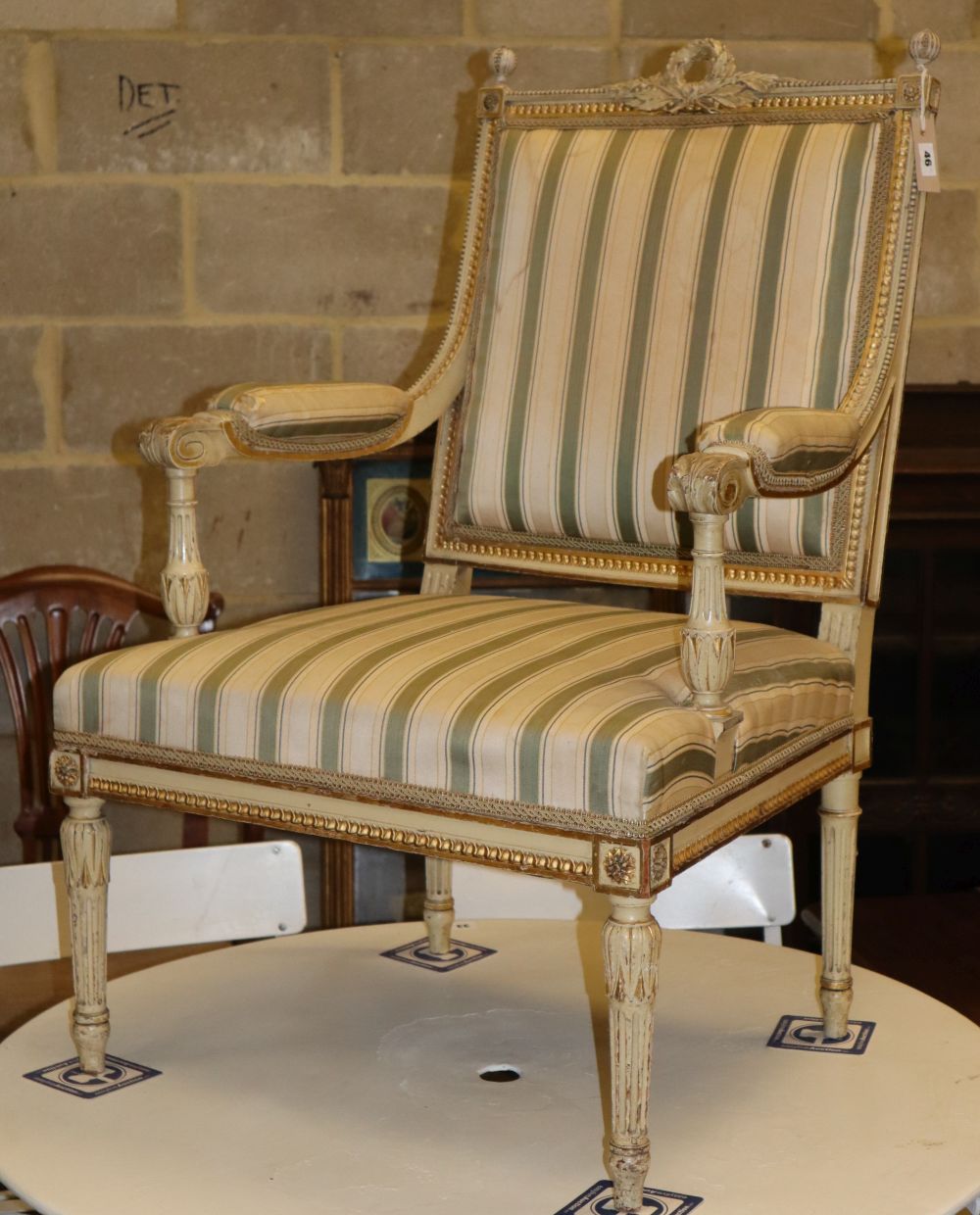 A late 19th / early 20th century French parcel gilt elbow chair